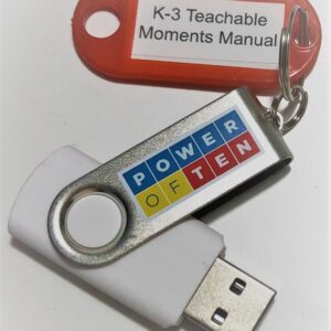 A picture of a USB drive with a keyring on it that has an attached label reading K-3 Teachable Moments Manual.