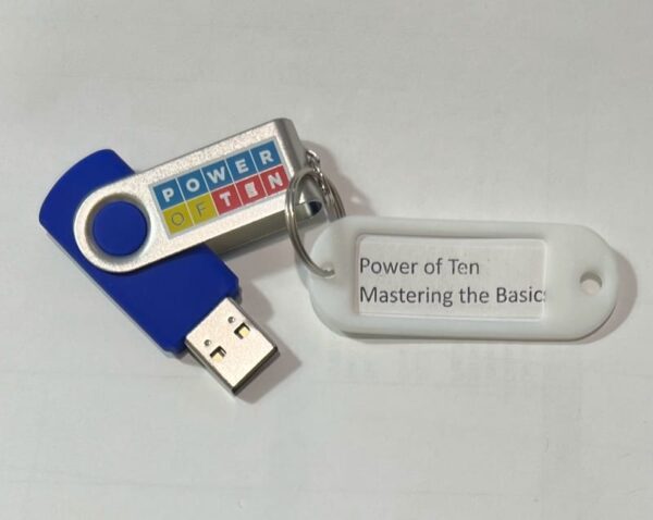 A picture of a USB drive with a keyring on it that has an attached label reading Power of Ten Mastering the Basics.